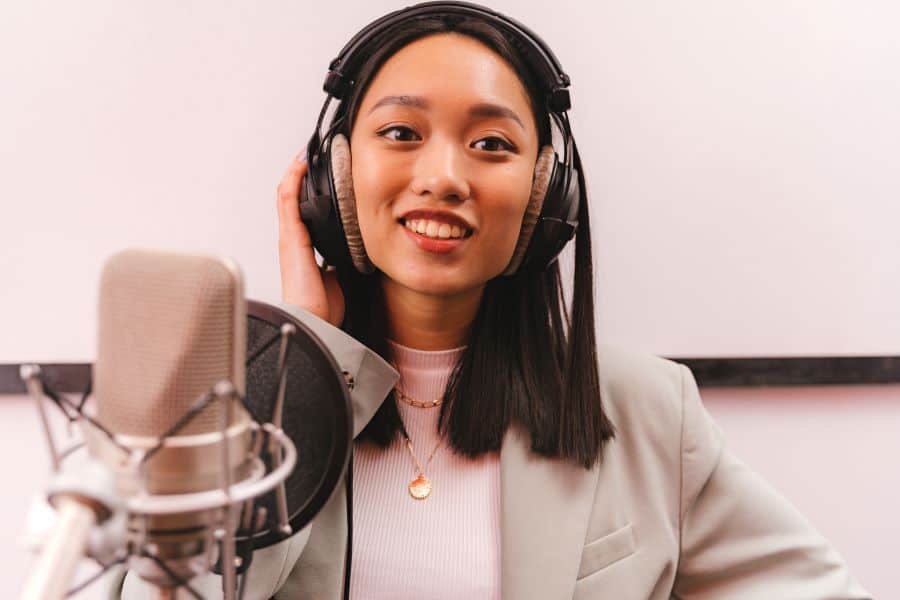 Podcast host wearing headphones while recording