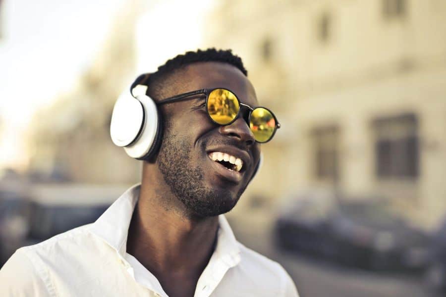 How to Listen to Podcasts and Music at the Same Time 1 young black man enjoying podcasts