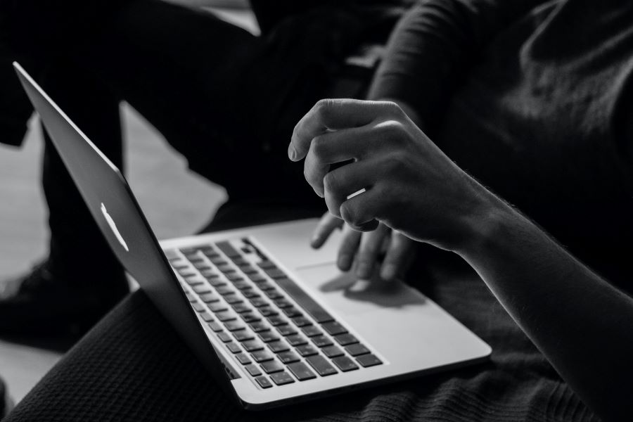 How Many Podcast Episodes Should You Launch With? 3 greyscale photo of a person using macbook