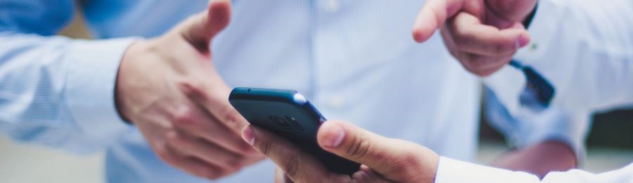 How Many Podcast Episodes Should You Launch With? 20 pointing to a phone