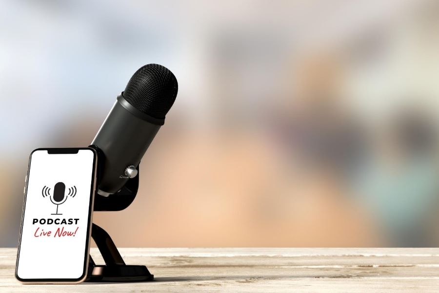 What Are Three Types Of Audio Editing Techniques? 2 smartphone leaning against a black condenser mic