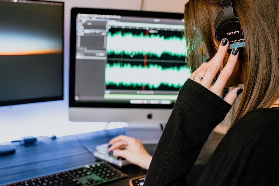 How Many Podcast Episodes Should You Launch With? 13 woman in black long sleeves editing a podcast