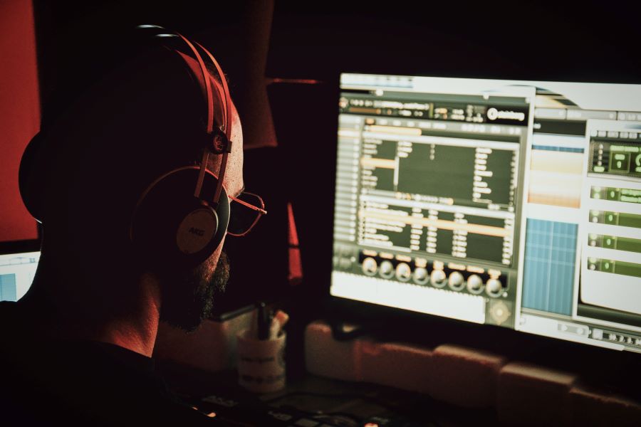 Buzzsprout vs Libsyn: Podcasting Platforms Compared 1 podcast editor in front of computer