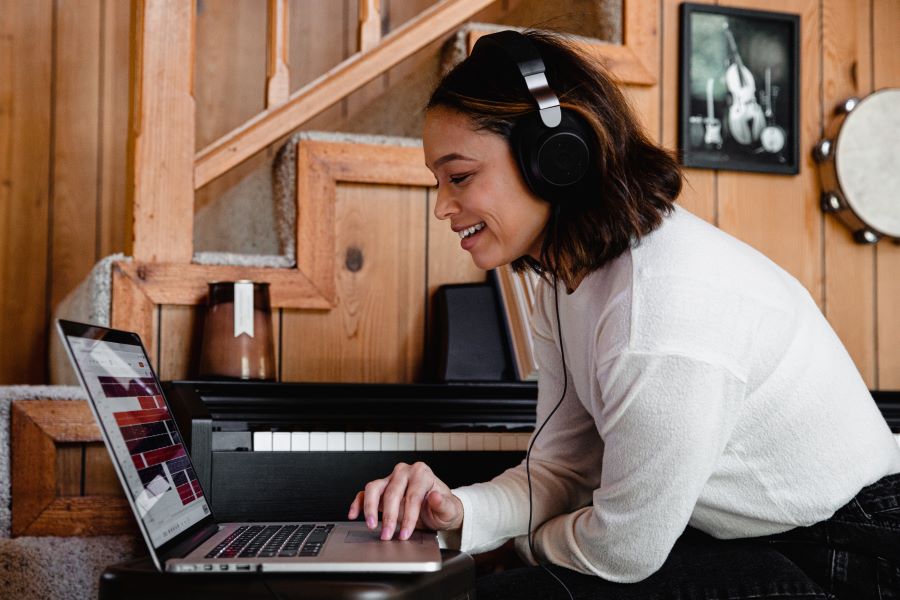 How to Delete a Podcast: The Ultimate Guide 1 woman in gray long sleeve in front of laptop